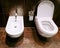 Open ceramic toilet bowl with bidet in bathroom