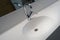 Open chrome faucet washbasin. Modern design of bathroom