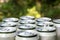 Open close-up of an aluminum can of beer on the background of a group of closed beer cans on a natural background