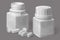 Open and closed jars with oval tablets and a lid on a gray