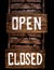 Open closed sign hanging in a door