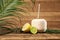 Open coconut and citrus fruits on wooden table