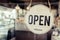 Open. coffee cafe shop text on vintage sign board hanging on glass door in modern cafe shop reopen after coronavirus quarantine is