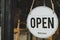 Open. coffee cafe shop text on vintage sign board hanging on glass door in modern cafe shop reopen after coronavirus quarantine is