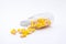 Open Container with Vitamin D3 Multivitamin capsules on white background