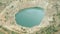 Open copper pit mine filled with blue water in Bulgaria, view from above