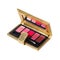 Open cosmetic set with eye shadows and brush in golden case