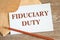 Open craft envelope and card with the words Fiduciary Duty