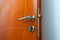 Open door of a family home. Close-up of the lock an armored door. White background.