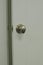 A open door with a oval silver knob