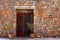 Open door and stone mediterranean wall(Greece)