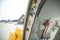Open door to a large airliner as seen from inside. Aircraft door frame, door handle and door barrier strap