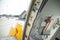 Open door to a large airliner as seen from inside. Aircraft door frame, door handle and door barrier strap