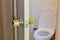 Open door to the toilet. Wooden interior door handle with a simple lock