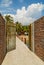 Open door walkway to nature brick fence wall