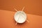 Open empty noodle bowl and pair of wooden sticks on brown background