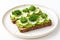 open faced avocado sandwich with white background