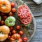 Open faced heirloom tomato and micro green sandwich surrounded by tomatoes.