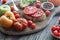 Open faced heirloom tomato sandwich on a rustic board with tomatoes all around.