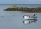 Open fibre glass boat, Garvel Built style, with outboard moored in a little cove at Donaghadee, Co Down.