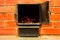 Open firebox of a furnace with glowing coal. Brick oven. Heating house with wood