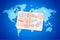 Open foreign passport with international visa stamps on blue world map with airline routes