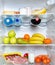 Open fridge full of fruits