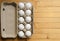 Open Full package of white eggs on a wooden background, copyspace.