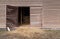 Open gate of an old wooden barn, rural architecture