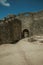 Open gate on stone wall in front the castle courtyard