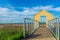 Open gate to nature. Boardwalk across marshland