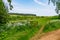 An open gate to a view of rolling English countryside