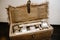 The open gift box is packed in sackcloth, with home products in wrappers. top view. Surprise. life in retro, rustic style.