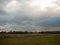 Open grass land country field plain green white cloudy sky