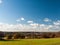 Open grass land farm agriculture plain blue sky above Wivenhoe