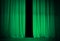 Open green or emerald curtains on theater stage