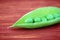 Open green pod of pea