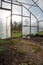 open greenhouse door with tools and irrigation lines