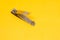 An Open Grey Nail Clipper in The Yellow Background with Oblique Shot