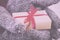 Open hands holding a present wrapped with a red ribbon Vintage R