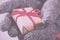 Open hands holding a present wrapped with a red ribbon Vintage R