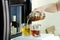 Open hatch of a mini bar in a modern refrigerator. home mini bar in the fridge. the owner pours guests alcoholic drinks, whiskey,