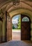 Open heavy lock door overlooking building in castle park