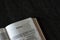 Open Holy Bible Book Hosea prophet from Old Testament on dark granite background