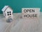 Open house symbol. Concept words \\\'Open house\\\' on wooden cubes near miniature houses.