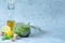 Open jar vegan dandelion pesto with garlic, lemon, olive oil and walnut on a gray background.