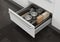 Open kitchen drawer with cooking utensils. Storage and organization of the kitchen.