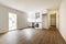 Open kitchen recently furnished in a newly renovated empty house with wooden floors and glass window leading to a terrace