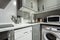 Open kitchen with white appliances, dishwasher, washing machine