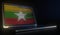 Open laptop and computer code on the screen composing flag of Myanmar. Modern information technology related 3d